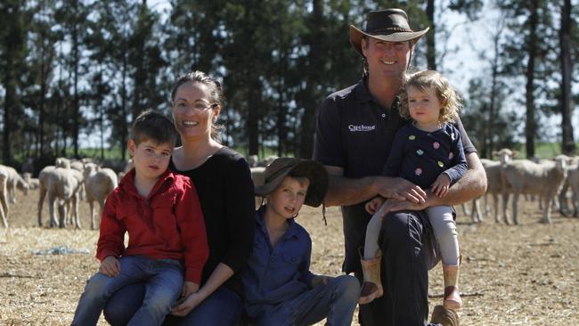 Brad and Katie Cox on their farm with James, 4, Edward, 7, and Georgia, 2. Picture: Dean Marzolla