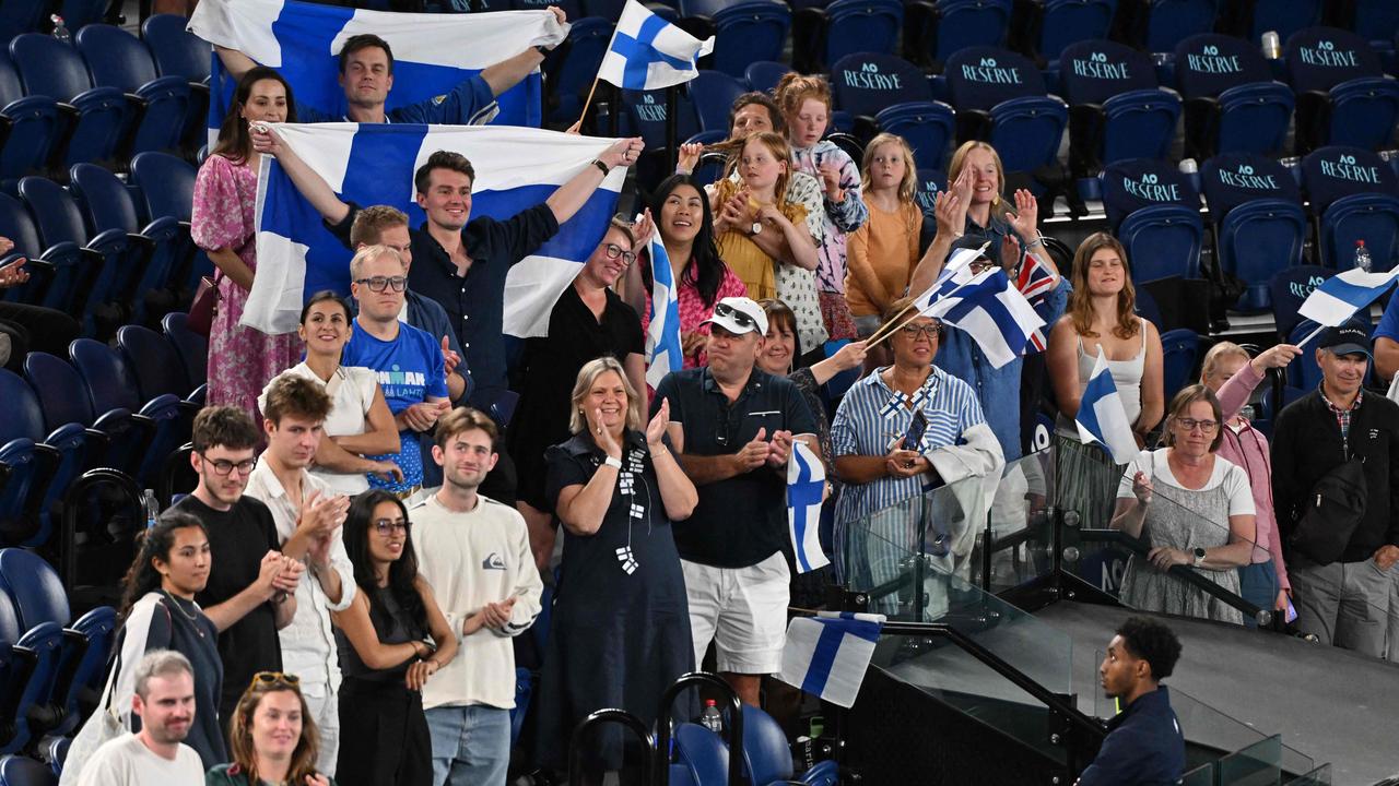 Supporters of Finland celebrate stuck around after the victory of Finland's Harri Heliovaara and Britain's Henry Patten in the men’s doubles. (Photo by WILLIAM WEST / AFP)