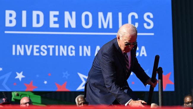 Joe Biden trips on the steps as he arrives on stage to speak about his Bidenomics agenda in October. Picture: AFP.