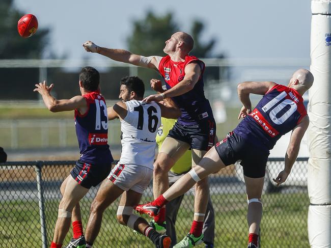 Shane Tennant punches the ball last season. He will captain Mt Eliza again this year. Picture: Valeriu Campan