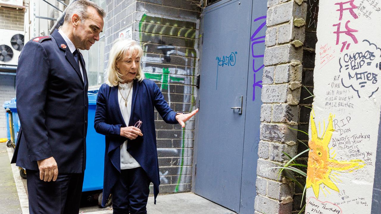 Major Brendan Nottle from the Salvation Army (left) and Katrina Korver placed flowers in the alleyway on Thursday. Picture: NCA NewsWire / Aaron Francis