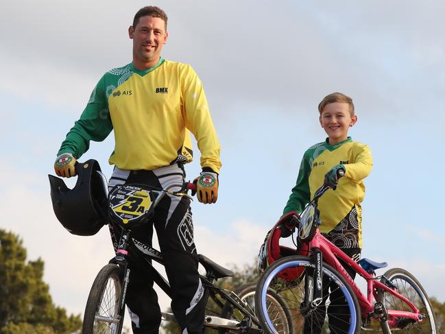 Jye Galloway, 8, and his dad Eddy pose for a photo at St Mary's BMX track today, May 24, 2018. They have both qualified for the world BMX Championships held in Azerbaijan next week. (AAP Image/David Swift)