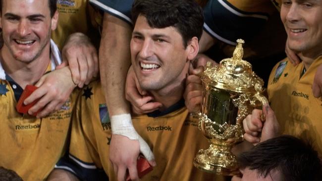 NOVEMBER 6, 1999 : Wallabies captain John Eales (L) clutches the William Webb Ellis trophy after Australia defeated France in 1999 World Cup final at Millennium Stadium in Cardiff, 06/11/99. Rugby Union