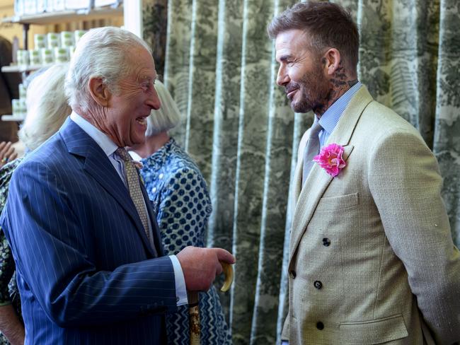 King Charles shares a laugh with David Beckham who wears a David Austin Rose — known as a King’s Rose. Picture: Paul Grover / Getty Images