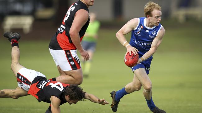 St Peter’s player Nick McGill manages to escape a diving Nick Thompson. Picture: AAP/Dean Martin