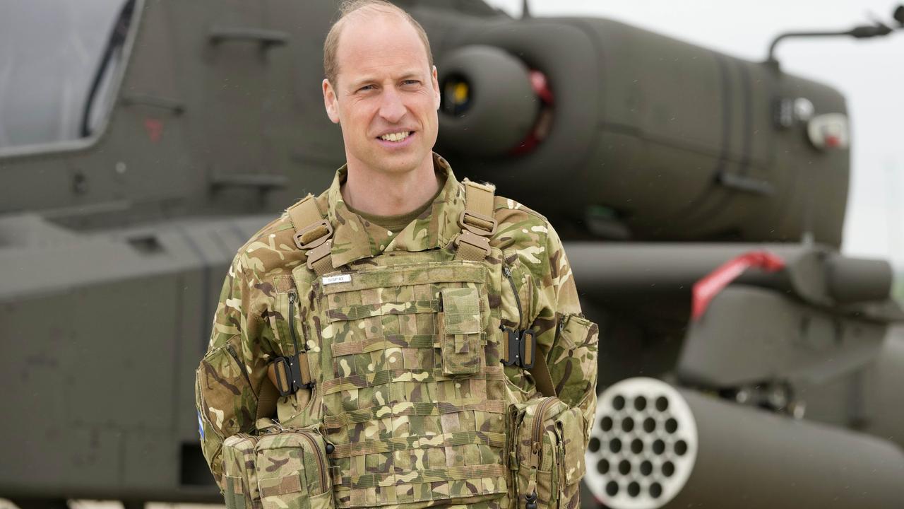 STOCKBRIDGE, UNITED KINGDOM - MAY 13: Prince William, Prince of Wales stands in front of an Apache helicopter at the Army Aviation Centre in Middle Wallop, on May 13, 2024 in Stockbridge, Hampshire. (Photo by Kin Cheung - WPA Pool/Getty Images)