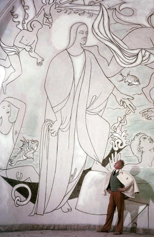 Grand scale ... Jean Cocteau dwarfed by his famous fresco at the Chapel of St Peter of the fisherman. Supplied: Paris Match magazine