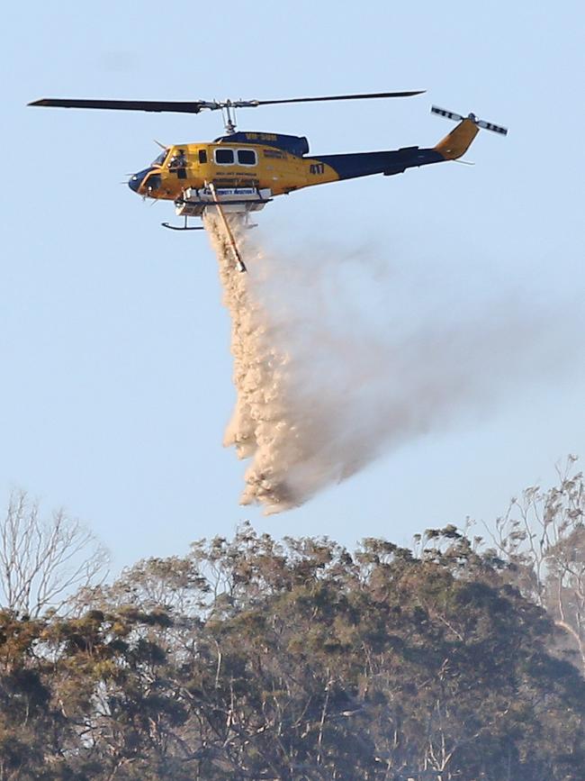 Bushfire at Cedar Creek. The fire burns out of control in the rugged terrain as helicopters waterbomb the blaze. Picture Glenn Hampson