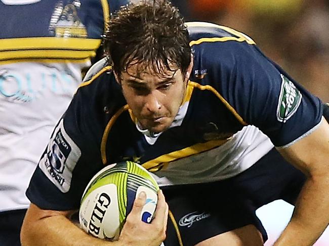 CANBERRA, AUSTRALIA - FEBRUARY 13: Sam Carter of the Brumbies is tackled during the round one Super Rugby match between the Brumbies and the Reds at GIO Stadium on February 13, 2015 in Canberra, Australia. (Photo by Stefan Postles/Getty Images)