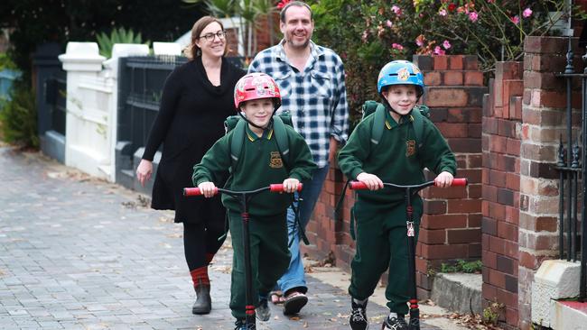 Jodie Cutler and her partner Craig watch eight-year-old twins, Gus, left, and Sid prepare for Monday’s ride to school in Marrickville, Sydney. Picture: John Feder