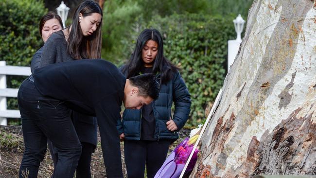 Thumith Chandrasena’s girlfriend and her family lay flowers at the scene. Picture: Brenton Edwards