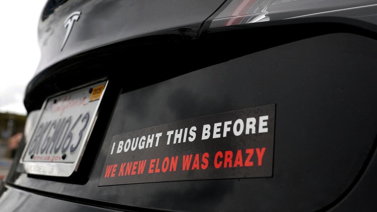 <!DOCTYPE html PUBLIC "-//W3C//DTD HTML 4.0 Transitional//EN" "http://www.w3.org/TR/REC-html40/loose.dtd"><html><body><p>The bumper sticker that reads &acirc;&#128;&#156;I bought this before we knew Elon was crazy&acirc;&#128;&#157; is popping up on Teslas all over the world. Picture: Justin Sullivan/Getty Images via AFP</p></body></html>