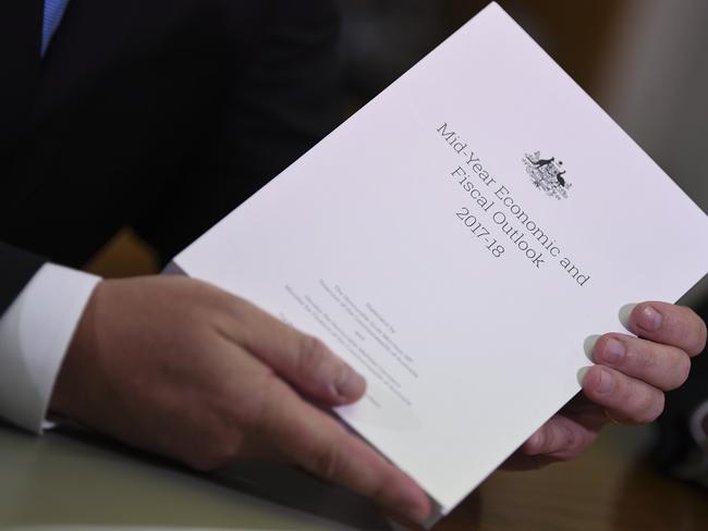 Australian Federal Treasurer Scott Morrison holds the report in his hands ahead of handing down the Mid-Year Economic and Fiscal Outlook 2017/18. Picture: AAP