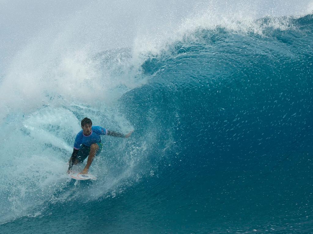 Australia's Jack Robinson gets a barrel in the men's surfing gold medal final at Teahupo'o, on the French Polynesian Island of Tahiti. Picture: Ben Thouard /POOL/AFP