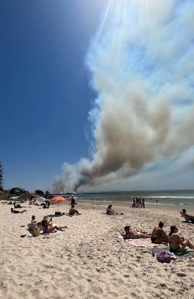 The Byron Bay bushfire sends a plume of smoke into the air over Main Beach. Picture: Facebook/Scott Tulloch