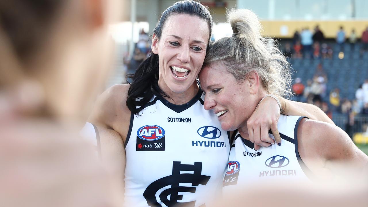 Katie Loynes and Alison Downie embrace in a team huddle after their final game with Carlton. Picture: Getty Images