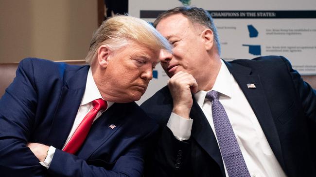 In one of his two tweets Mr Trump, pictured with Mr Pompeo in 2019, attempted to link the cyber attack to his efforts to undercut Mr Biden’s election win. Picture: AFP