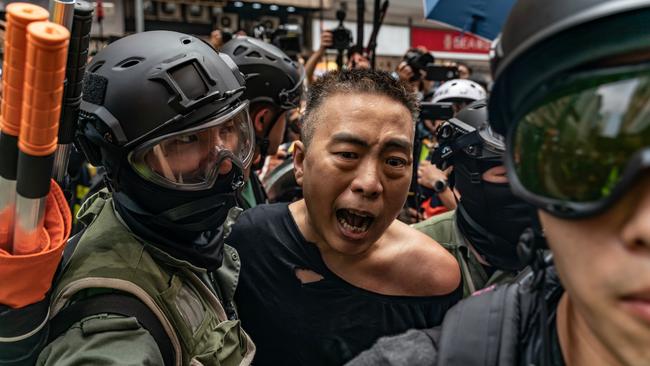 A pro-democracy protester is arrested by riot police during a rally in Hong Kong. Picture: Getty Images