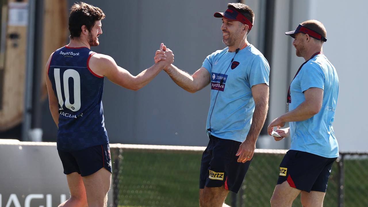 . Angus Brayshaw shakes hands with and hugs assistant coach Troy Chaplin during Melbournes training session at Casey Fields, Cranbourne Photo by Michael Klein.
