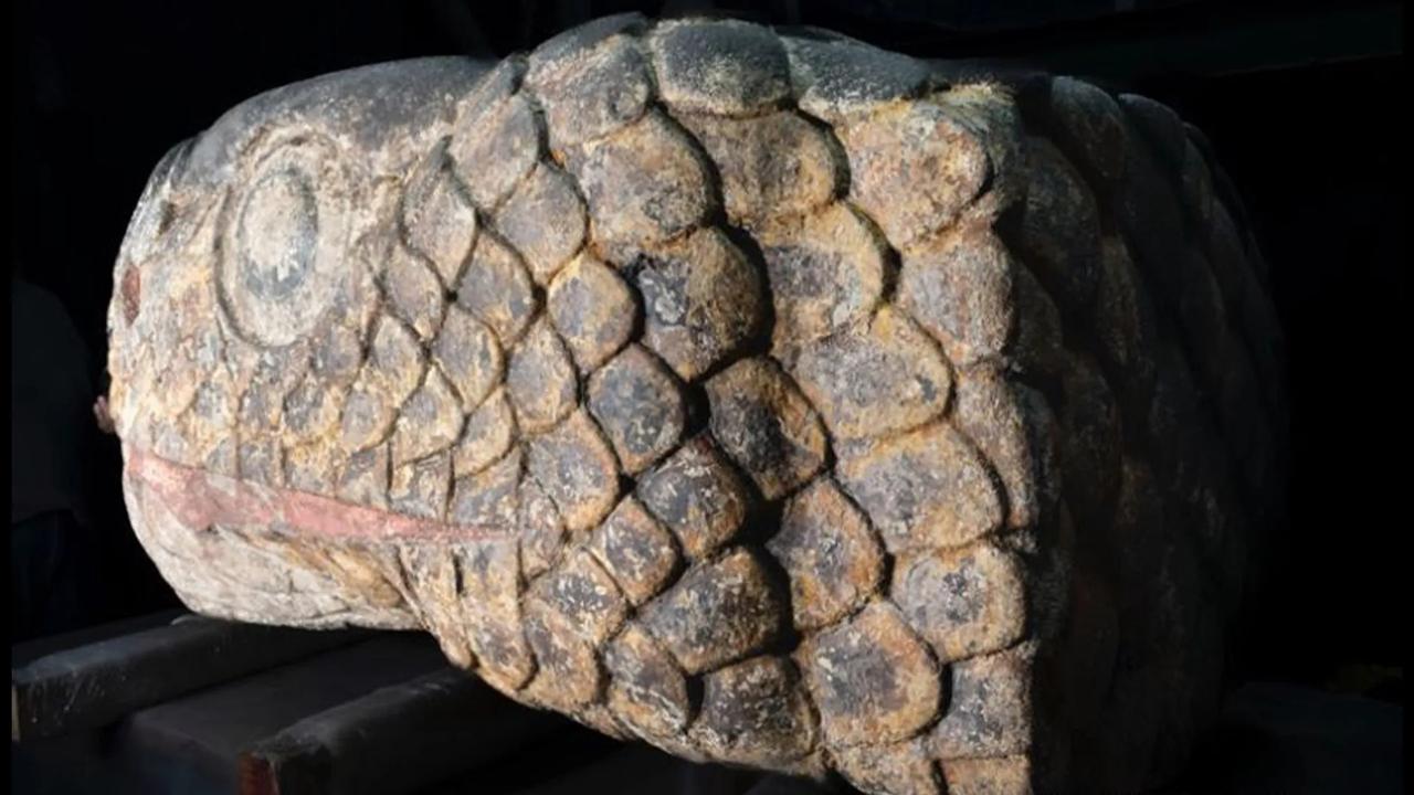 A giant, colourful statue of a snake’s head from the Aztec empire has been shaken free after an earthquake. Picture: LANCIC/UNAM