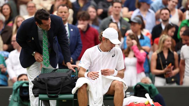 An official checked on Alex de Minaur after the match. (Photo by Sean M. Haffey/Getty Images)