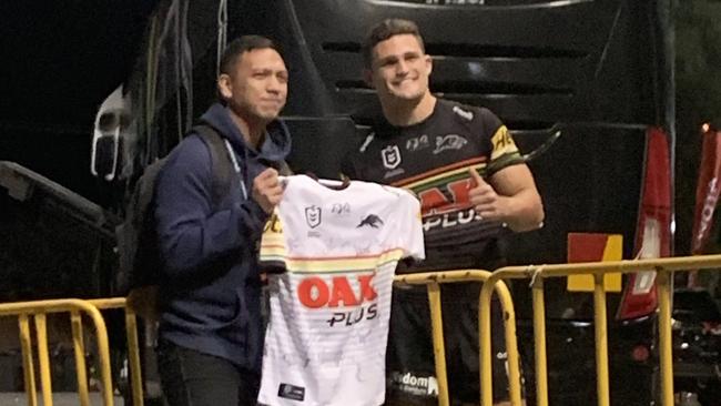 Journalist Matt Encarnation is presented with a Panthers jersey by Nathan Cleary. Picture: Twitter