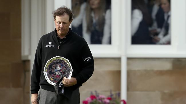 Phil Mickelson holds the runner-up silver plate.