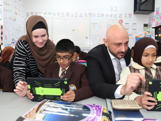 CANTERBURY BANKSTOWN EXPRESS/AAP. (L-R) Teacher Ms Jade McGinty, student Saim Muhammad(10), Principal Alan Khoder and student Maryum Khaira(10) pose for photos in Lakemba, Friday, 13th September 2019. Al Hikma College, Lakemba, is rated among the fast fastest growing schools in Western Sydney. (AAP IMAGE / Robert Pozo)