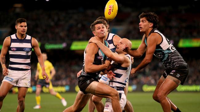 Port Adelaide’s Ryan Burton is tackled by Gary Ablett of the Cats. Picture: James Elsby/AFL Photos via Getty Images