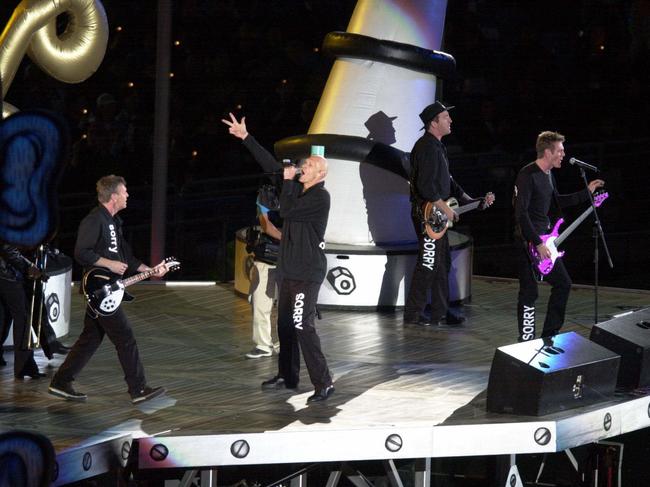 ‘Mission accomplished’ … with their secret Sorry suits on, the band rocked the Sydney Olympics closing ceremony in more ways than one. Picture: Nathan Edwards.