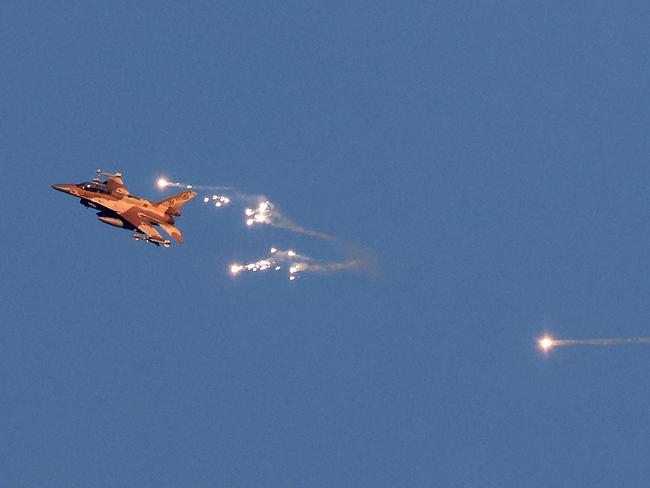 An Israeli Air Force fighter jet firing flares as it flies to intercept a hostile aircraft that launched from Lebanon over the border. Picture: AFP