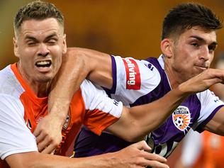 Thomas Kristensen (left) of the Roar takes on Brandon Wilson (right) of the Glory during the round 12 A-League match between the Brisbane Roar and Perth Glory at Suncorp Stadium in Brisbane, Thursday, December 21, 2017. (AAP Image/Darren England) NO ARCHIVING, EDITORIAL USE ONLY.