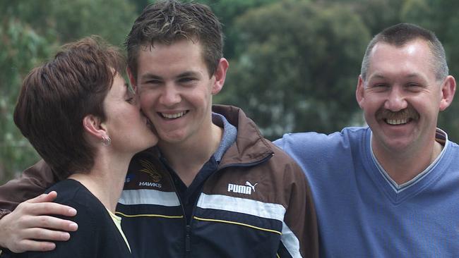 “Kick him up the arse and get him into gear”: Luke Hodge as a 17-year-old on draft day, with mother Leanne and father Bryson. Picture: David Crosling