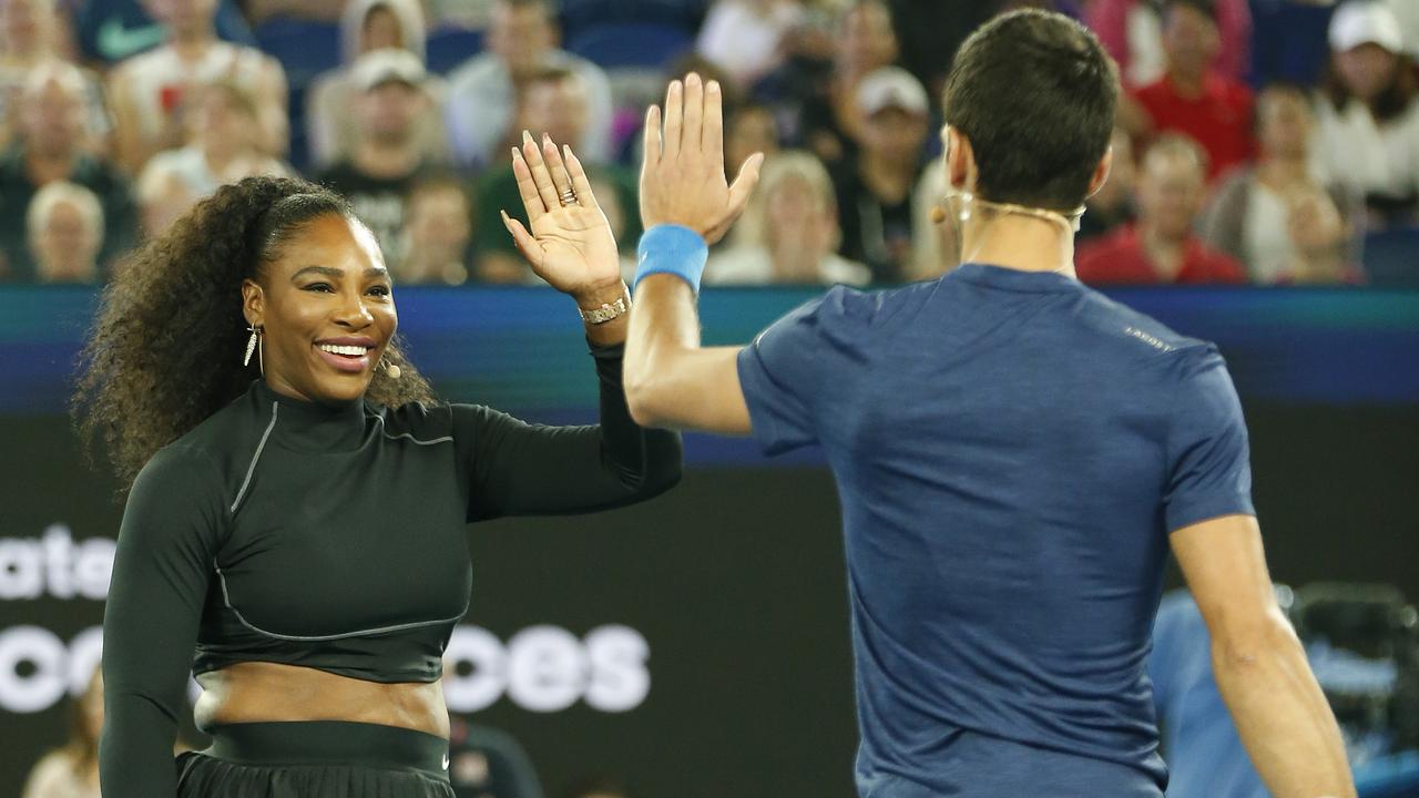 Serena Williams and Novak Djokovic high-five during the Rally for Relief charity event. (Photo by Darrian Traynor/Getty Images)