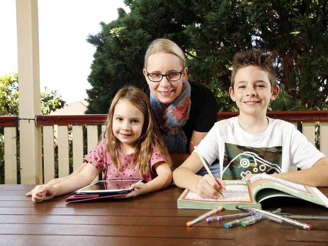 Amber Smith with Campbell, 8, and Amelia, 4, at home in Brisbane. Amber has been home schooling both kids since the schools closed due to the coronavirus. Picture: AAP