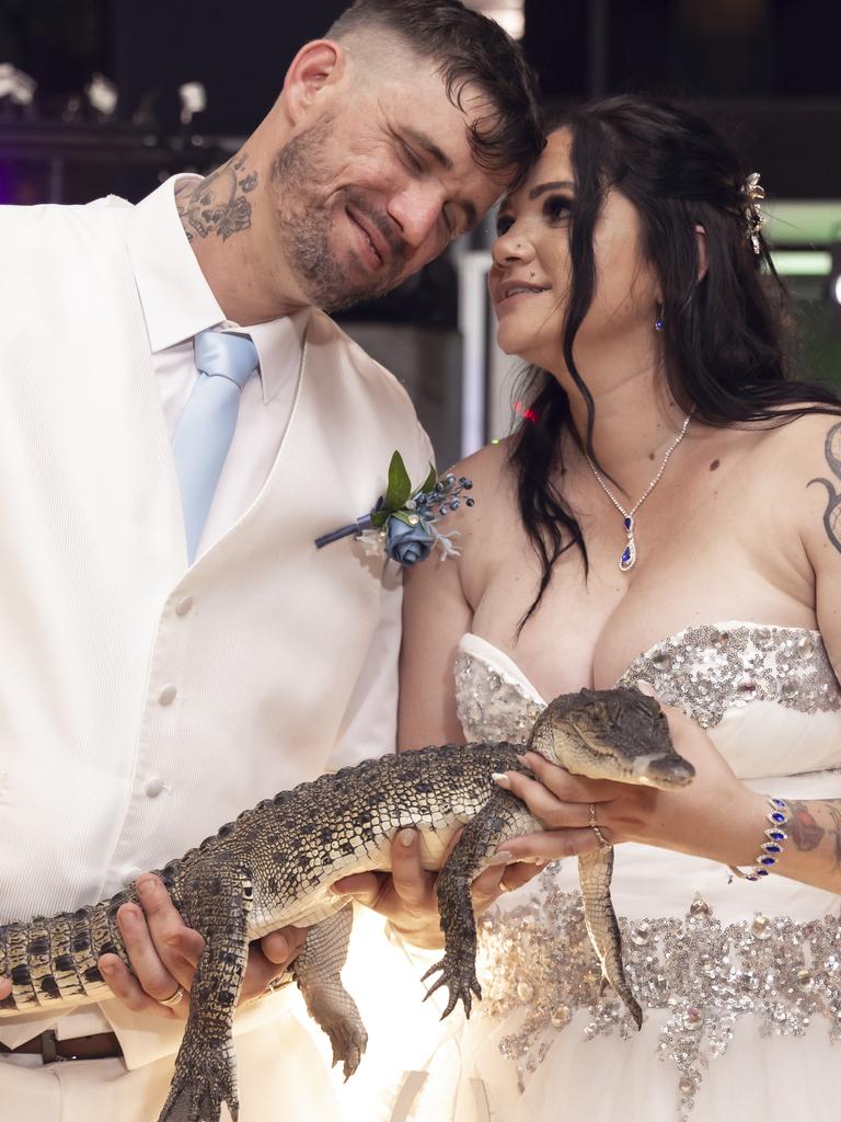 A wedding snap with a difference – Jessie and Latoya pose with a baby croc during their wedding shoot at Crocosaurus Cove. Photograph David Artisan Photography