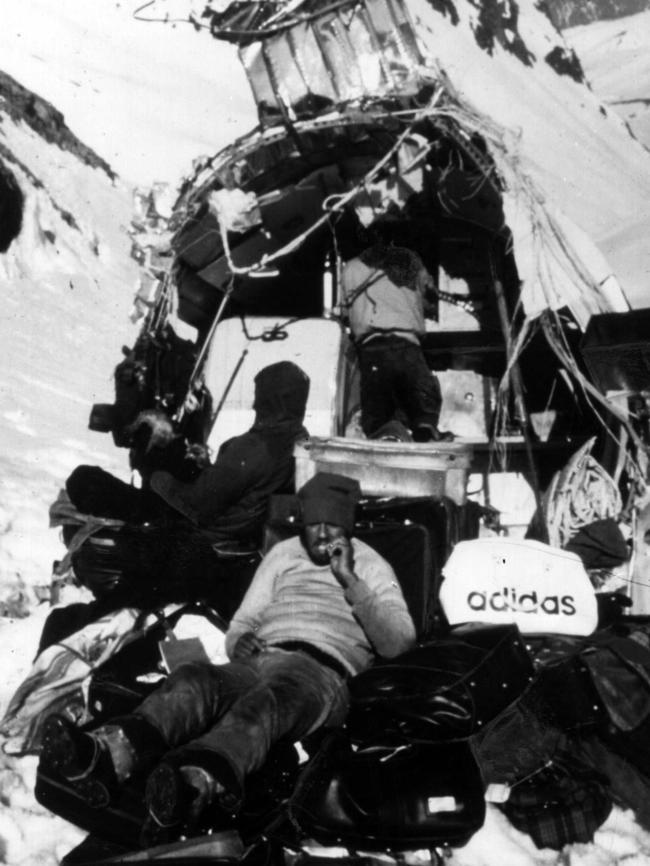 Waiting ... Uruguayan rugby union team near the remains of their plane, which crashed in the Andes. Picture: Supplied