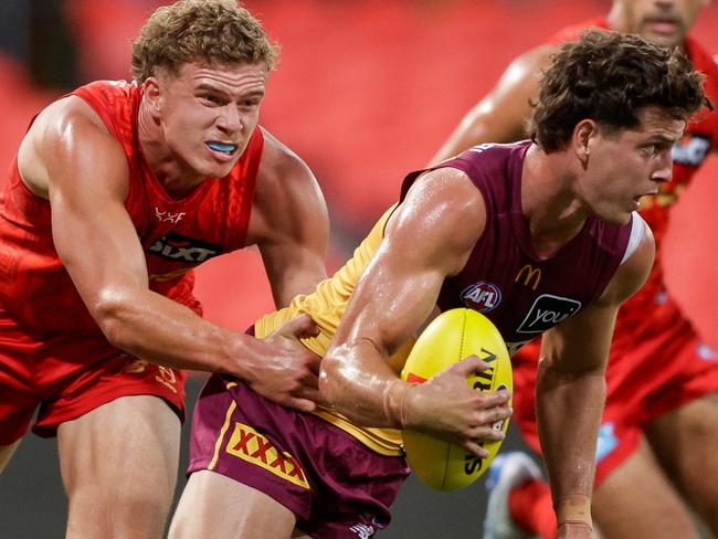 GOLD COAST, AUSTRALIA - FEBRUARY 20: Jarrod Berry of the Lions is tackled by Jed Walter of the Suns during the 2025 AFL Match Simulation between Brisbane Lions and the Gold Coast Suns at People First Stadium on February 20, 2025 in the Gold Coast, Australia. (Photo by Russell Freeman/AFL Photos via Getty Images)