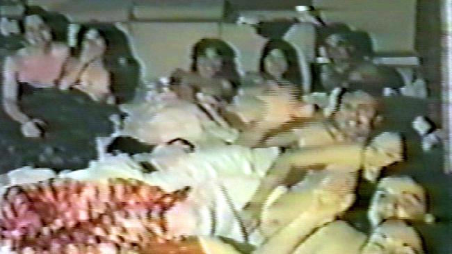 A scene from a Children of God DVD called The Family Cult Videos shows adults under covers.