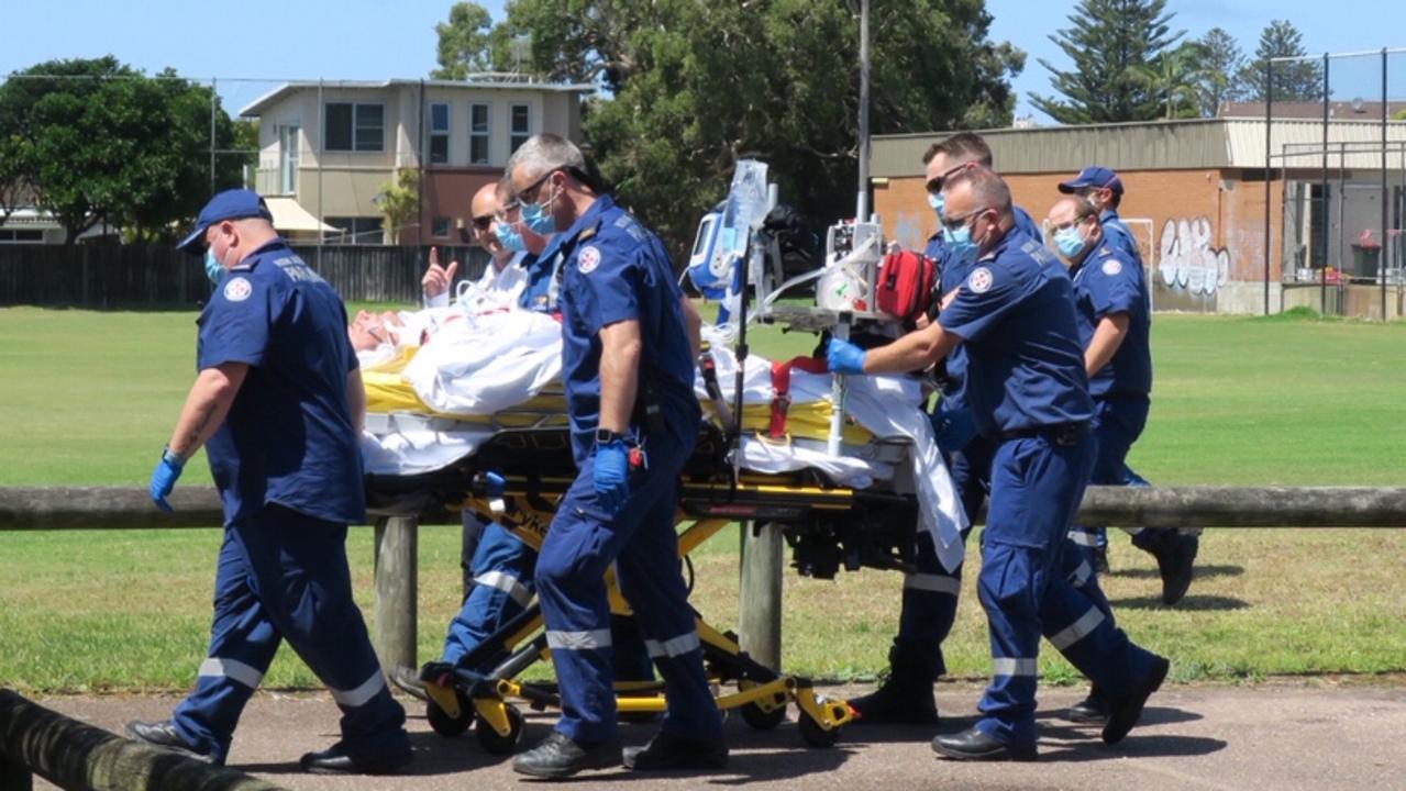 Paramedics worked to treat the man before he was taken to hospital via helicopter. Picture: Richard Noone