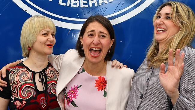 New South Wales Premier Gladys Berejiklian (centre) reacts with sisters Rita (left) and Mary (right), who have joined her for the final day of campaigning. Picture: Dean Lewins/AAP