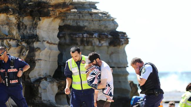 Mr Constable and Malachi were escorted from the beach. Picture by Peter Lorimer.