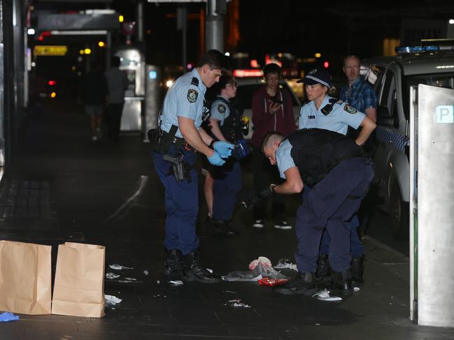 Officers collect evidence at he scene of the vicious attack. Picture: Bill Hearne