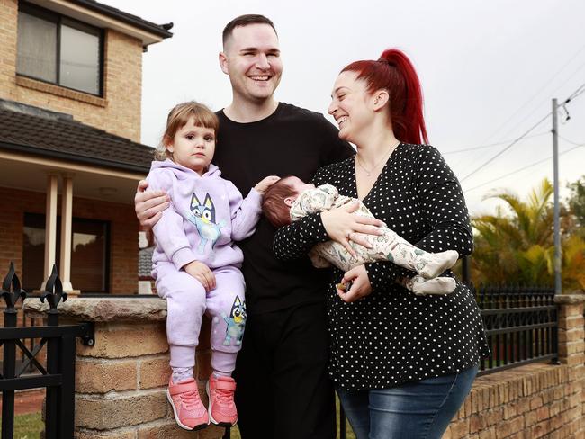 SATURDAY TELEGRAPH. MAY 26, 2023.Pictured at home in Greenacre today is Eddie Dileen and his wife Francesca and their kids Aurora and baby Forrest. Picture: Tim Hunter.