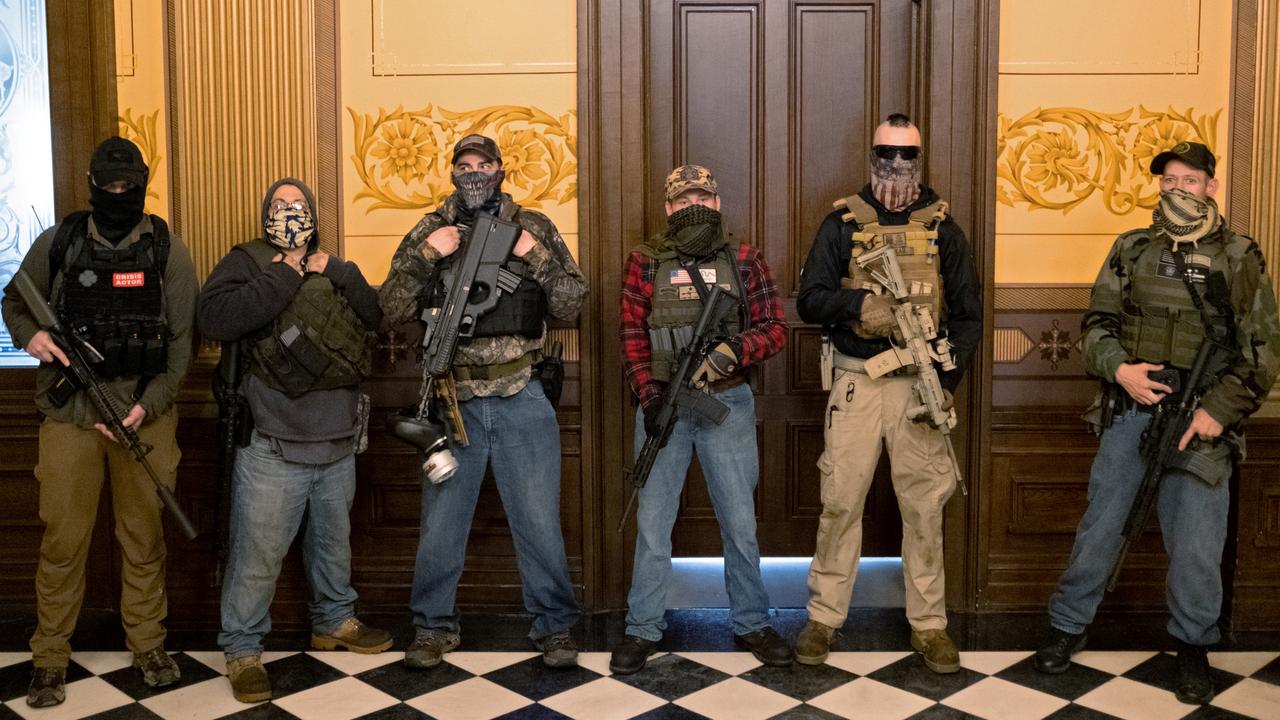 A militia group with no political affiliation from Michigan stands in front of the Governor’s office after protesters occupied the state capitol building on April 30.