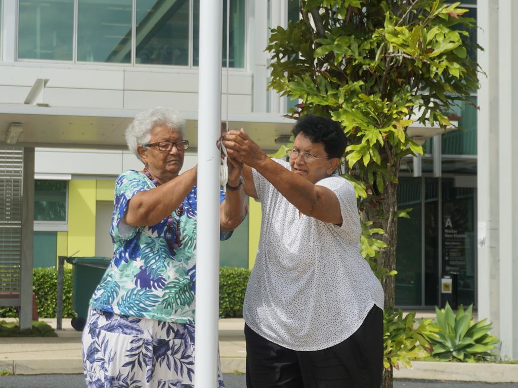 Eunice and Carmel Armstrong raised the Australian South Sea Islander Flag at Mackay Hospital in a ceremony to recognise the valuable contribution of the Australian South Sea Islander community. Photo: Fergus Gregg