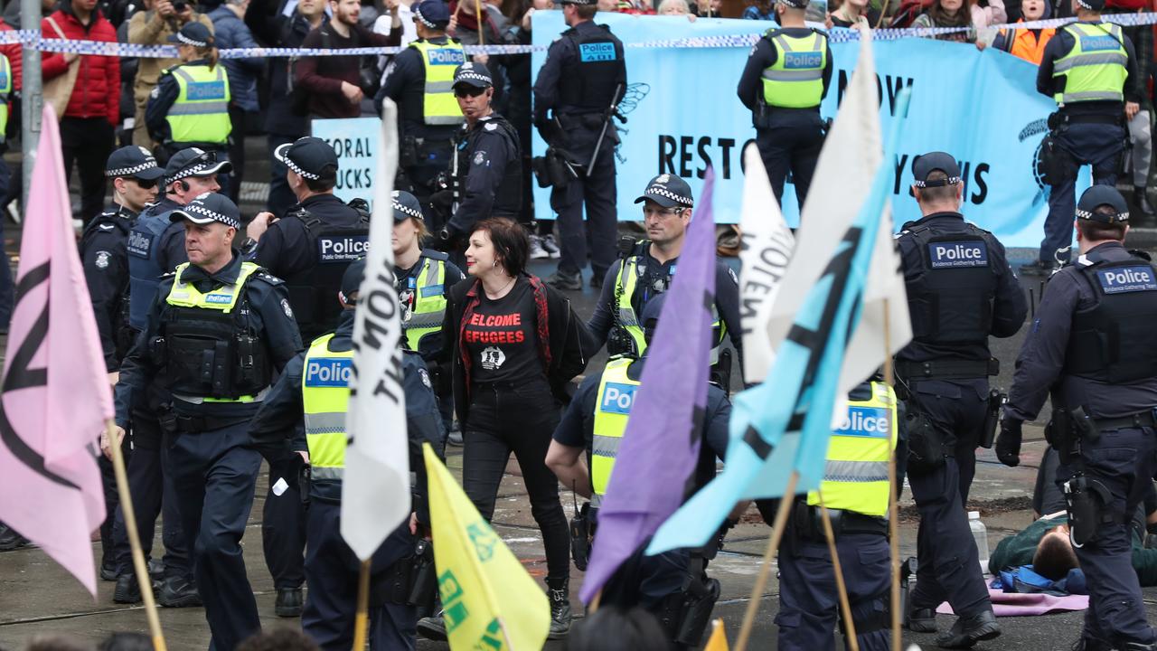 Protesters look on as an activist is arrested. Picture: AAP Image/David Crosling