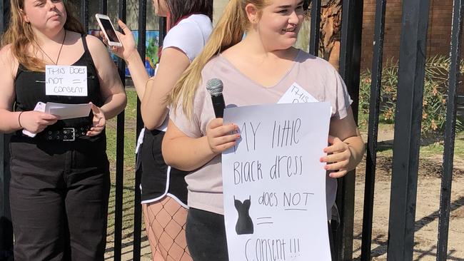 Ngara Kennedy with a sign at the protest at Swansea High School. Picture: Amy Ziniak