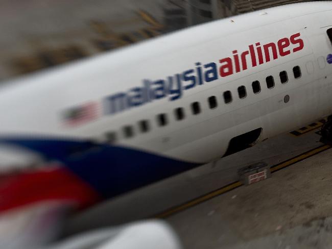 (FILES) This file photo taken with a tilt and shift lens on June 16, 2014 shows a Malaysia Airlines plane parked on the tarmac at Kuala Lumpur International Airport in Sepang. The official search for MH370 may have been called off but experts believe the missing airliner will one day be found, perhaps either by deep-sea miners or treasure hunters lured by a huge cash reward. After spending almost three years and 150 million USD on a deep sea hunt for the Malaysian passenger jet in the remote Indian Ocean off western Australia, top aviation investigators have been forced to admit they have come up with nothing. / AFP PHOTO / MANAN VATSYAYANA / TO GO WITH Australia-Malaysia-China-MH370-aviation,FOCUS by Glenda KWEK