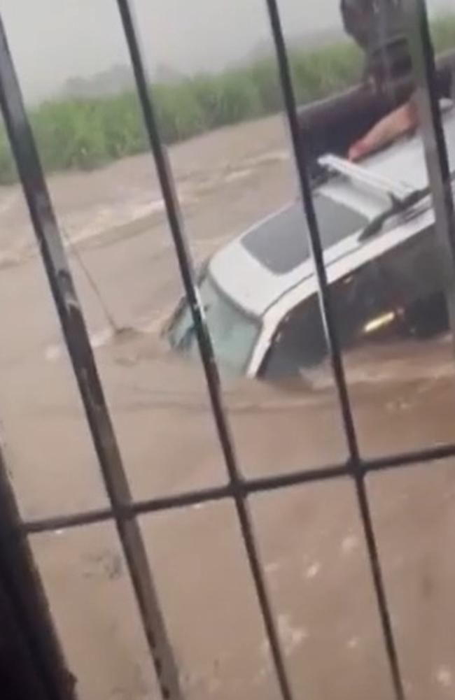 Will Graham came to the rescue of a motorist who became trapped in floodwaters at Eton in the Mackay region on January 12, 2023. The driver was rescued in an excavator bucket. Picture: 7News Mackay.